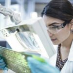 Female_technician_examining_motherboard