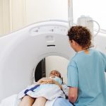 Technician_performing_CAT_scan_of_patient_in_hospital